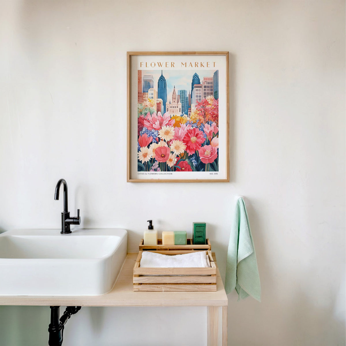 Philadelphia flower market print in an oak frame above a white bathroom sink with folded towels