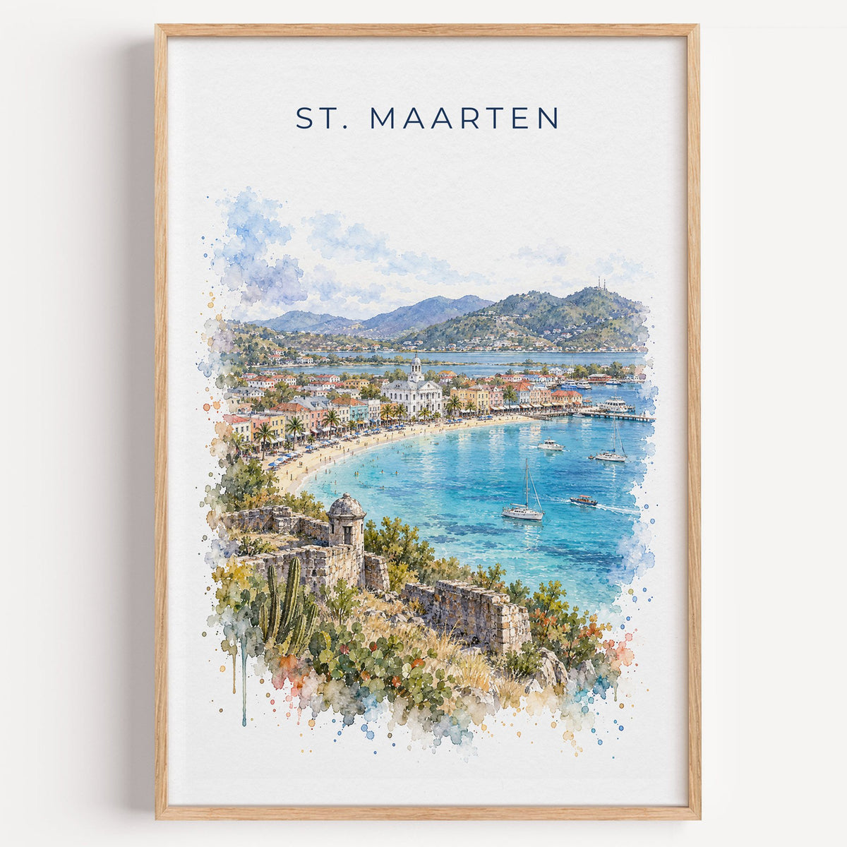 St. Maarten watercolor print in a light oak frame on a plain white wall