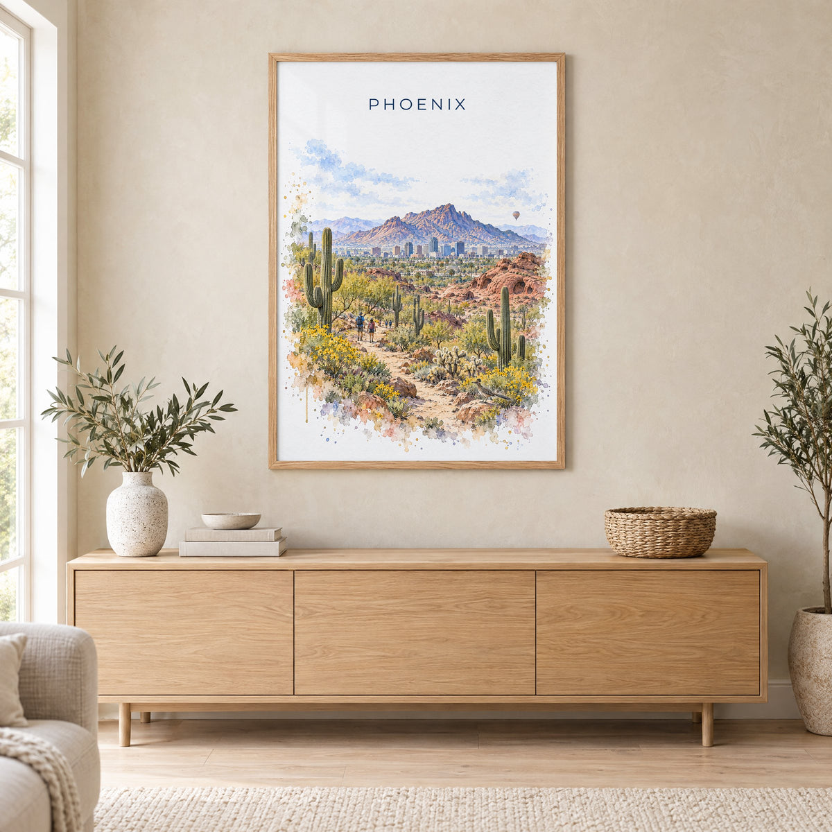 Phoenix watercolor print in an oak frame above a light wood sideboard in a Scandinavian living room