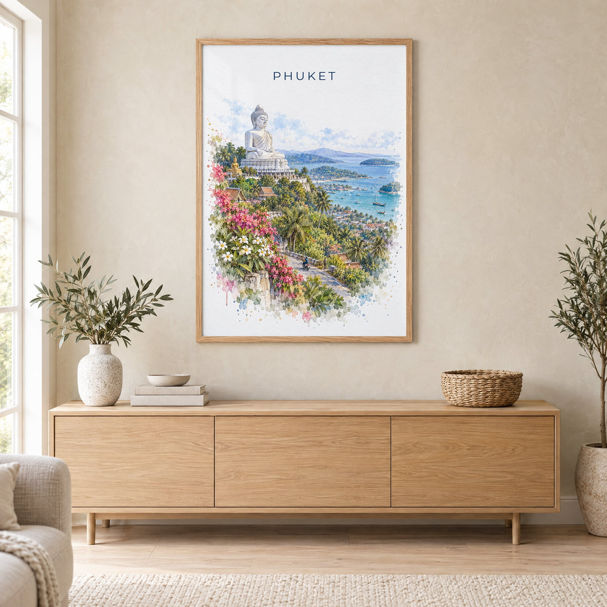 Phuket watercolor print in an oak frame above a light wood sideboard in a Scandinavian living room
