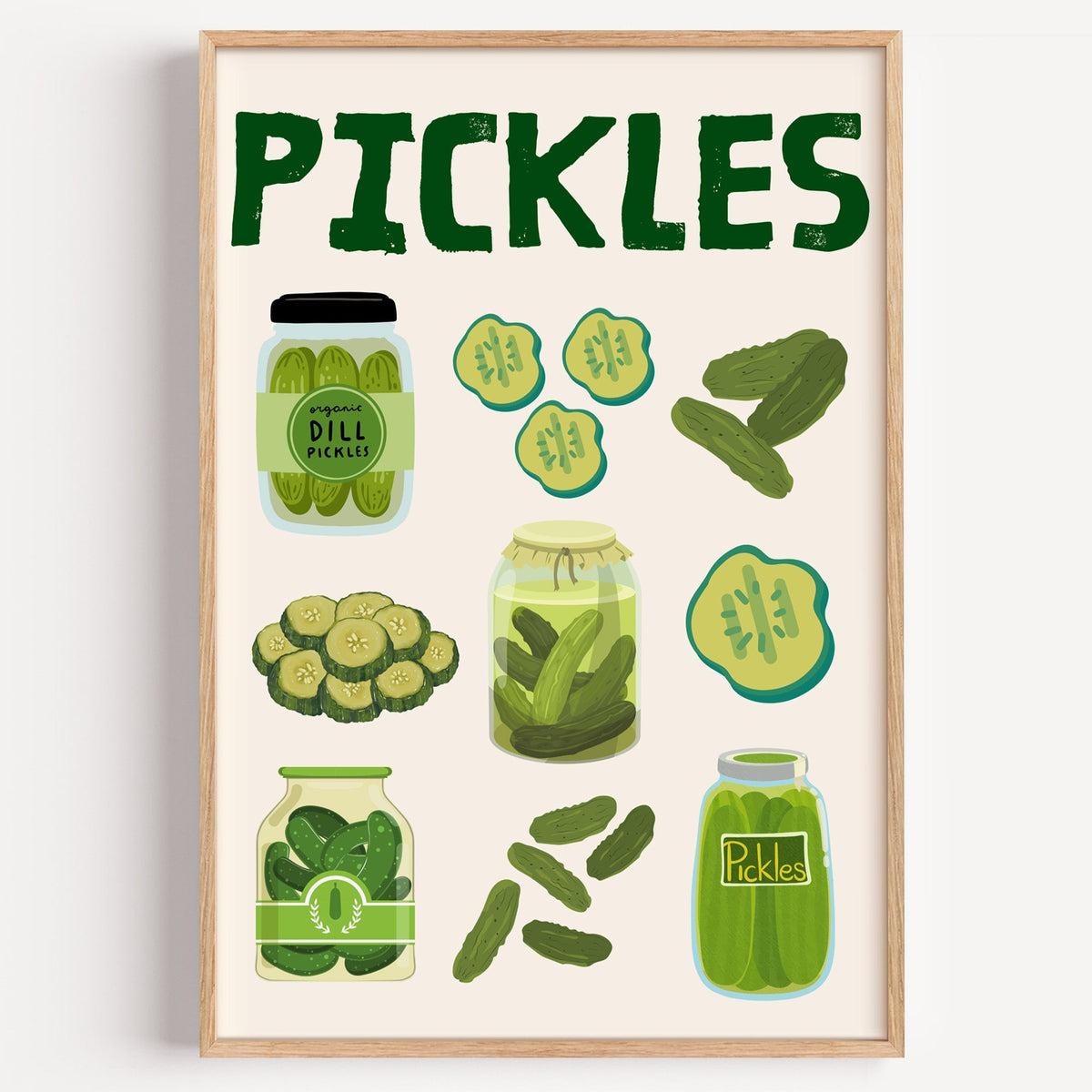 Pickles jars and slices chart print in a light oak frame on a plain white wall