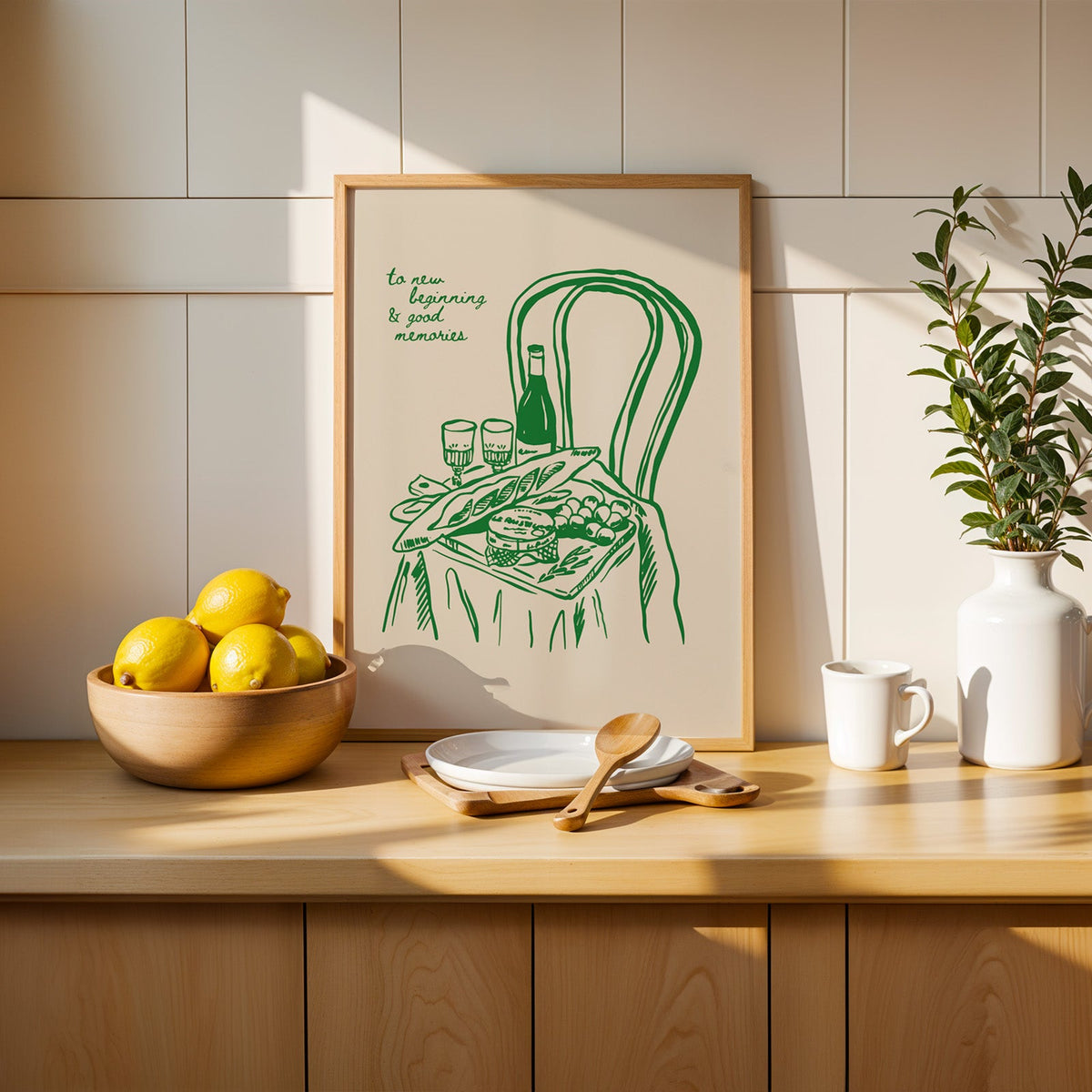 Picnic basket print in a slim oak frame beside a wooden bowl of lemons
