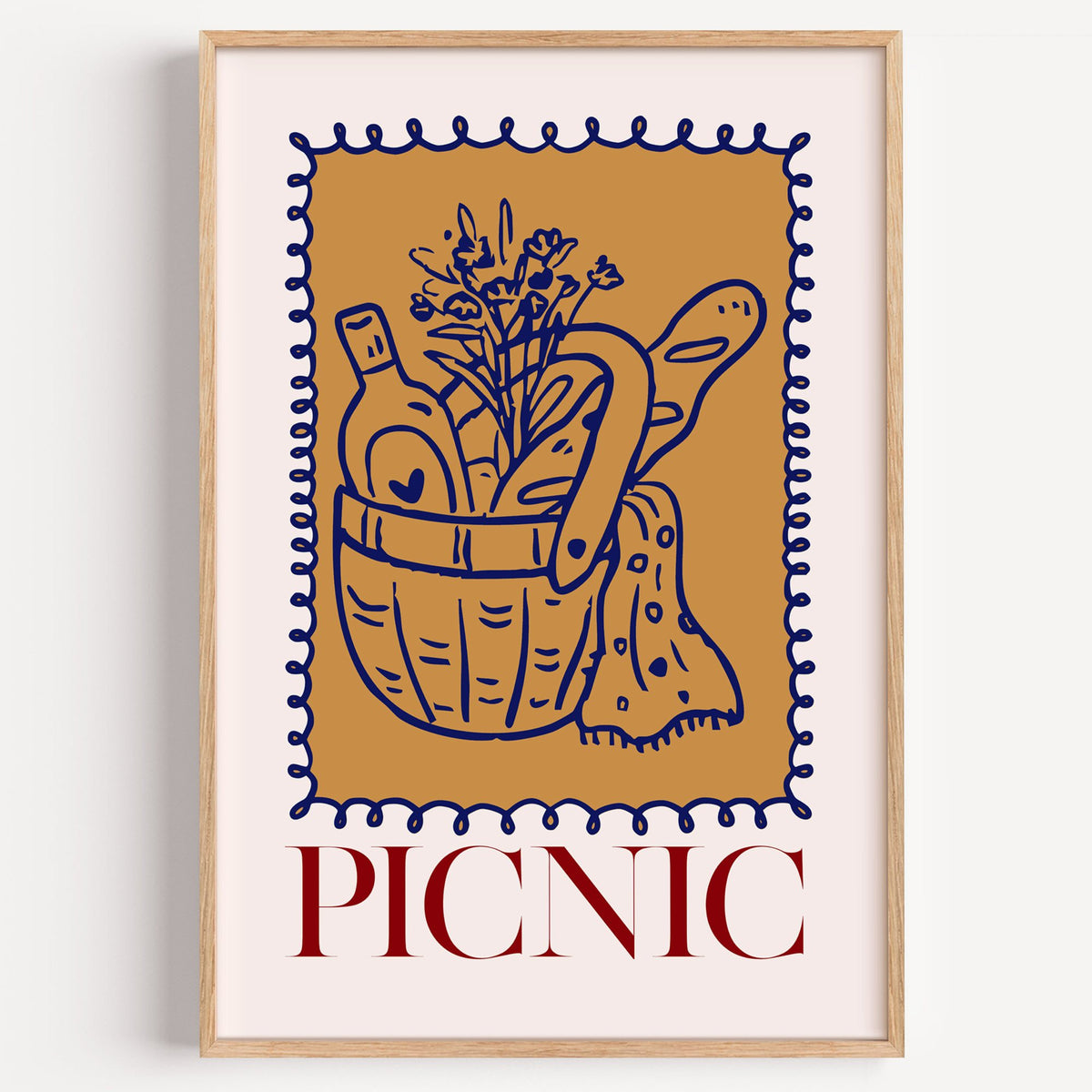 PICNIC basket wine and baguette stamp print in a light oak frame on a plain white wall