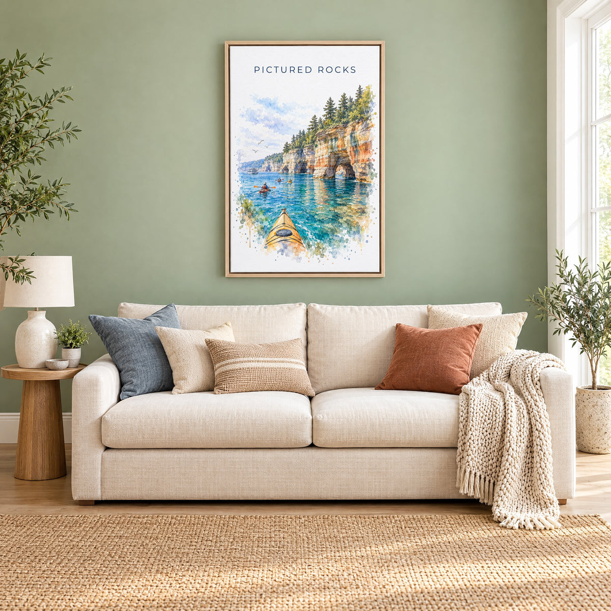 Pictured Rocks watercolor print as a natural floater canvas above a cream linen sofa on a sage green wall