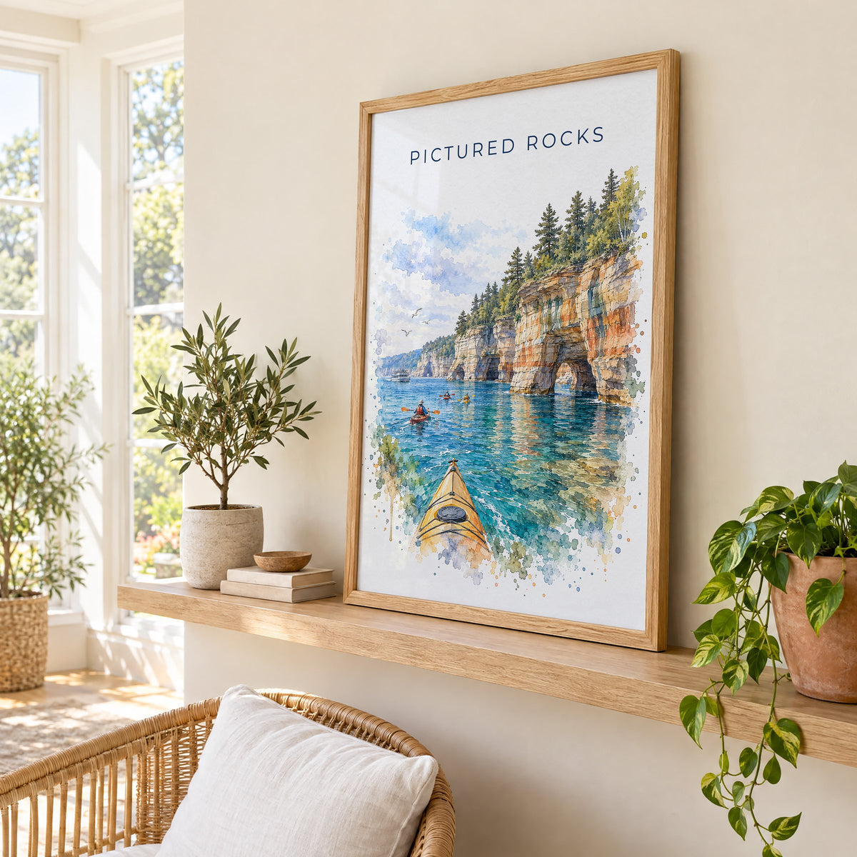 Pictured Rocks watercolor print in an oak frame on a picture ledge in a sunlit sunroom