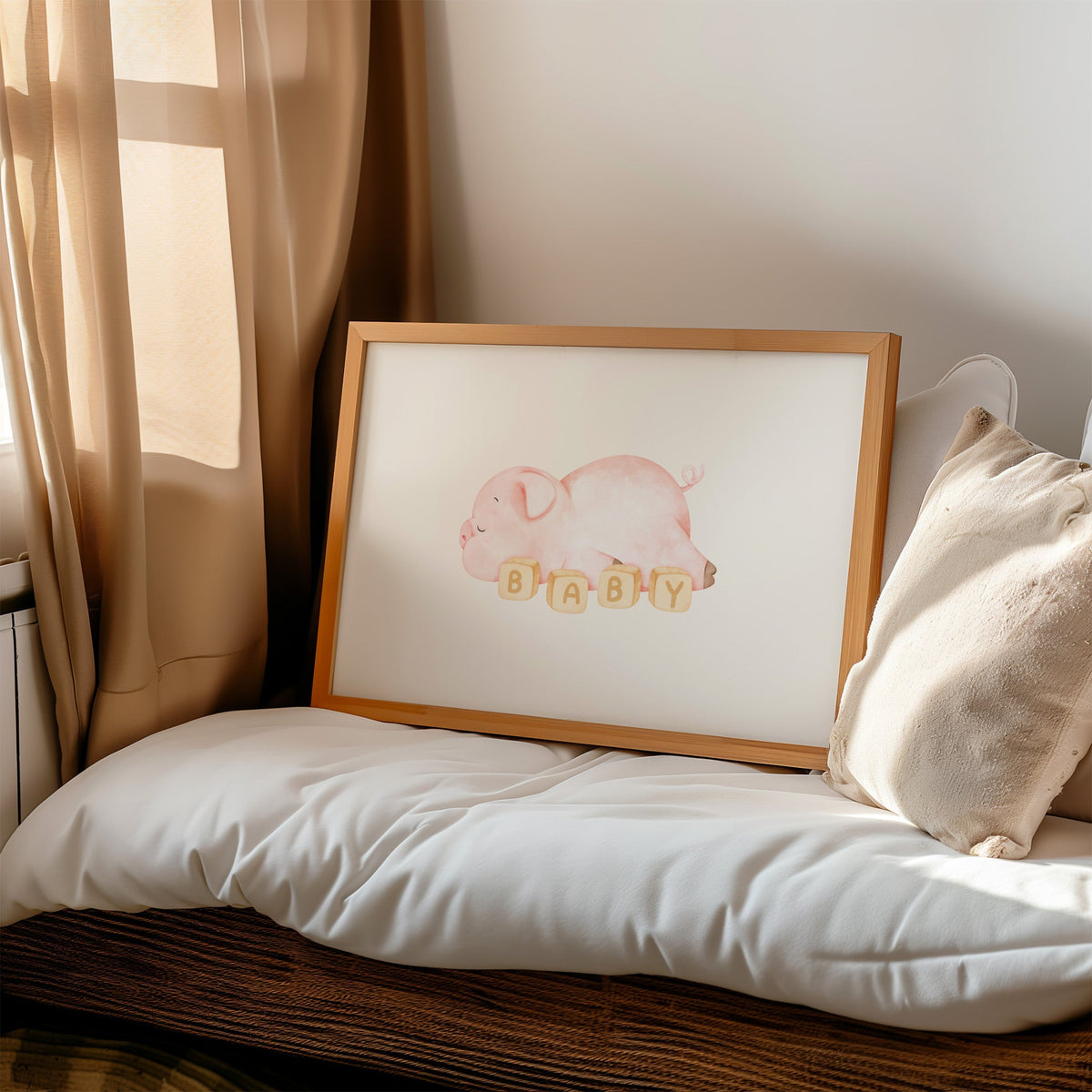 Sleeping pink piglet behind BABY blocks nursery print in a honey wood frame on a cushioned window seat by sheer curtains