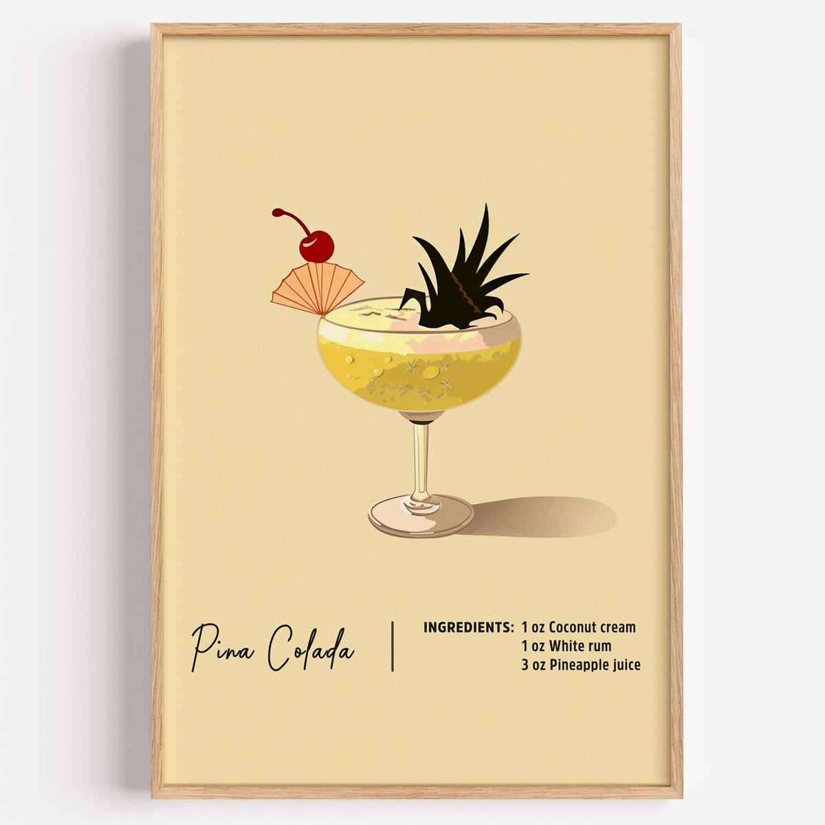 Pina colada recipe print in a light oak frame on a plain white wall
