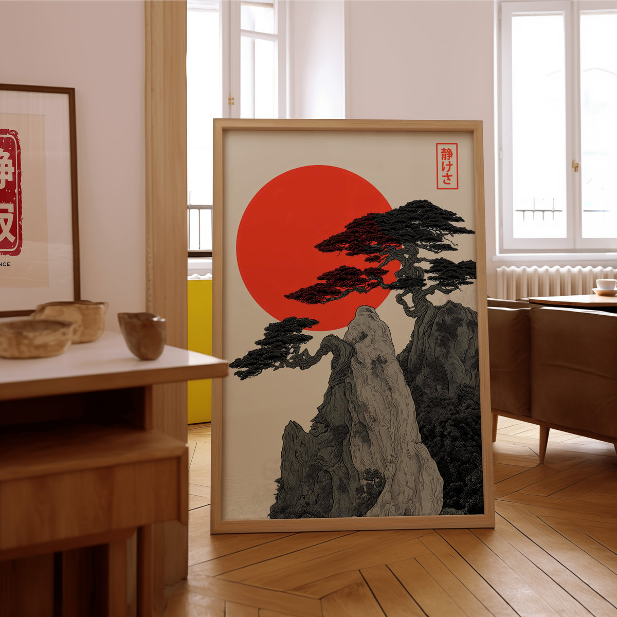 Ink pine cliff with red sun print in an oak frame on the parquet floor of a sunlit living room