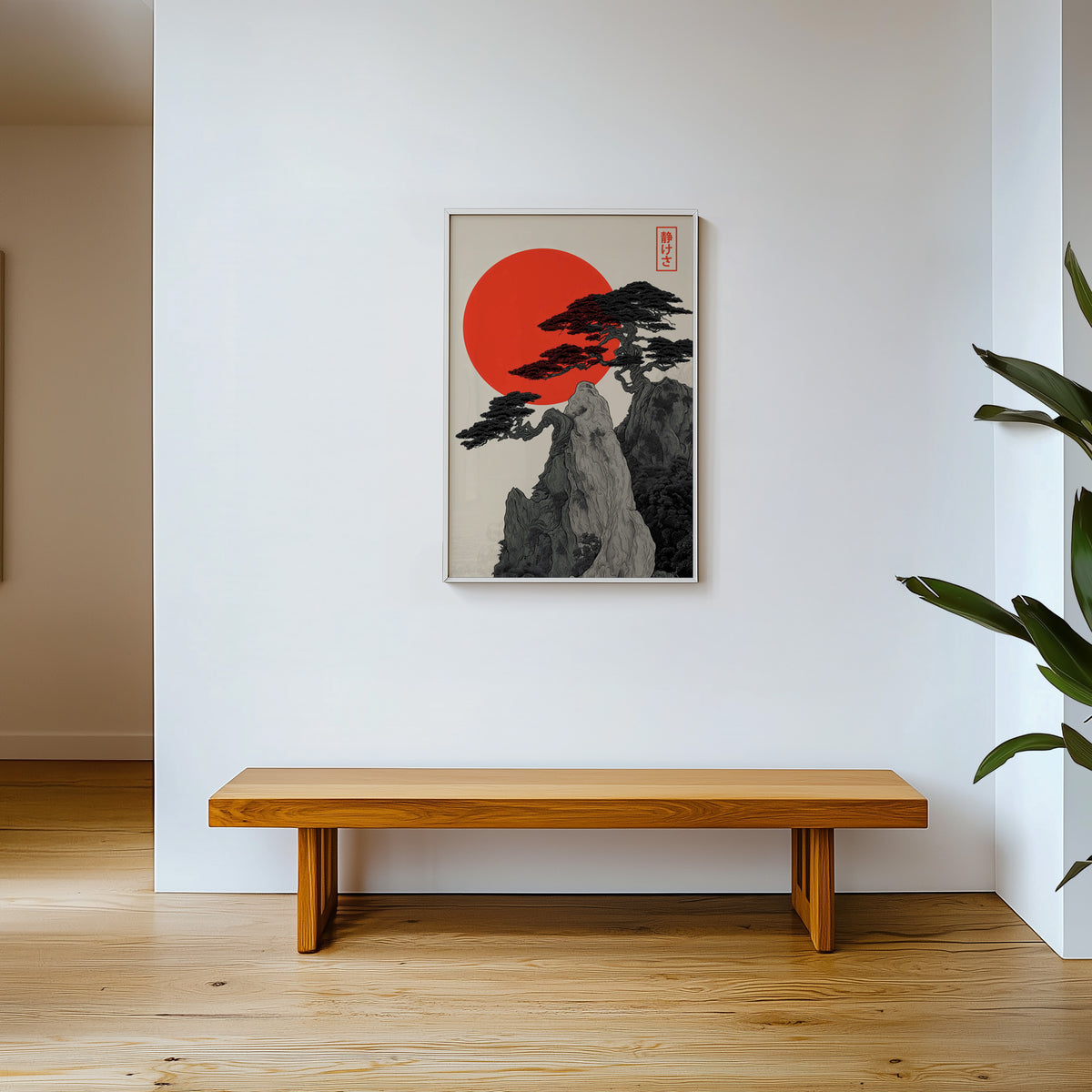 Ink pine cliff with red sun print shown in a white frame above a wooden entryway bench