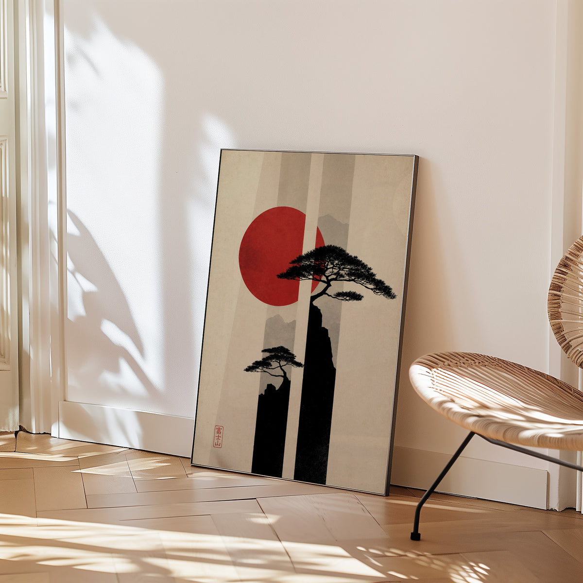 pine cliffs with red sun and stripes print in a black frame leaning on a herringbone floor beside a woven rattan chair