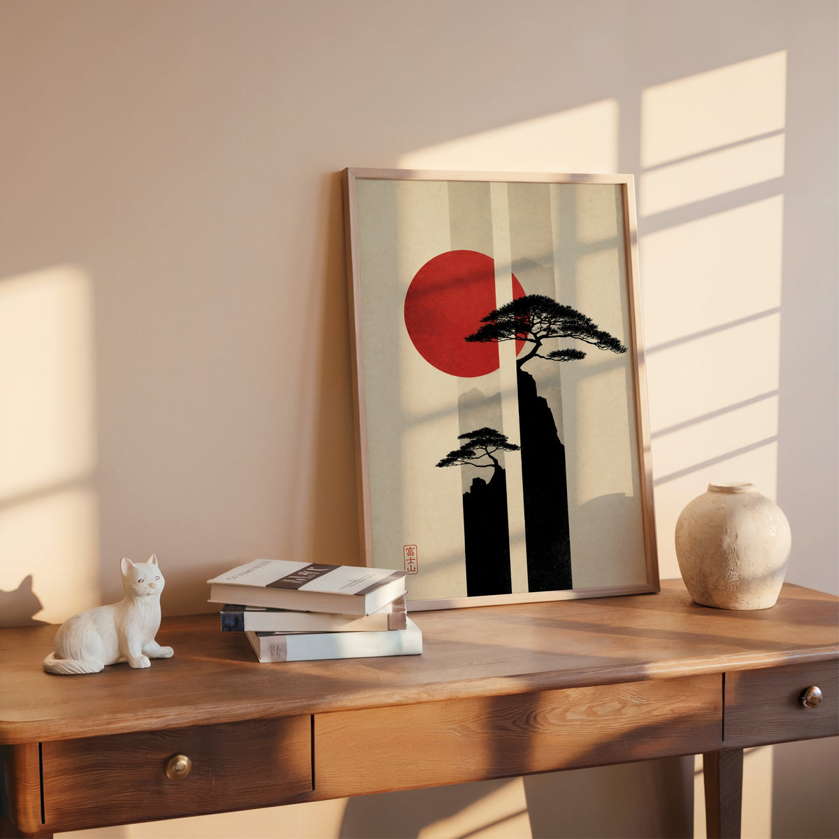 pine cliffs with red sun and stripes print shown in a rose gold frame leaning on a wooden writing desk with books
