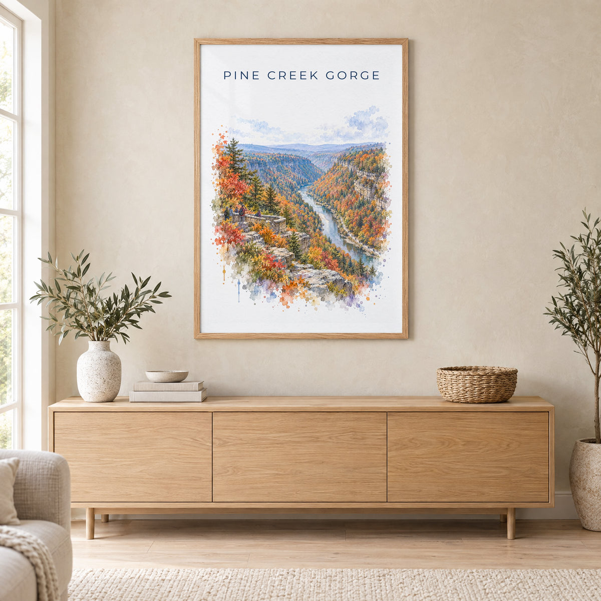 Pine Creek Gorge watercolor print in an oak frame above a light wood sideboard in a Scandinavian living room