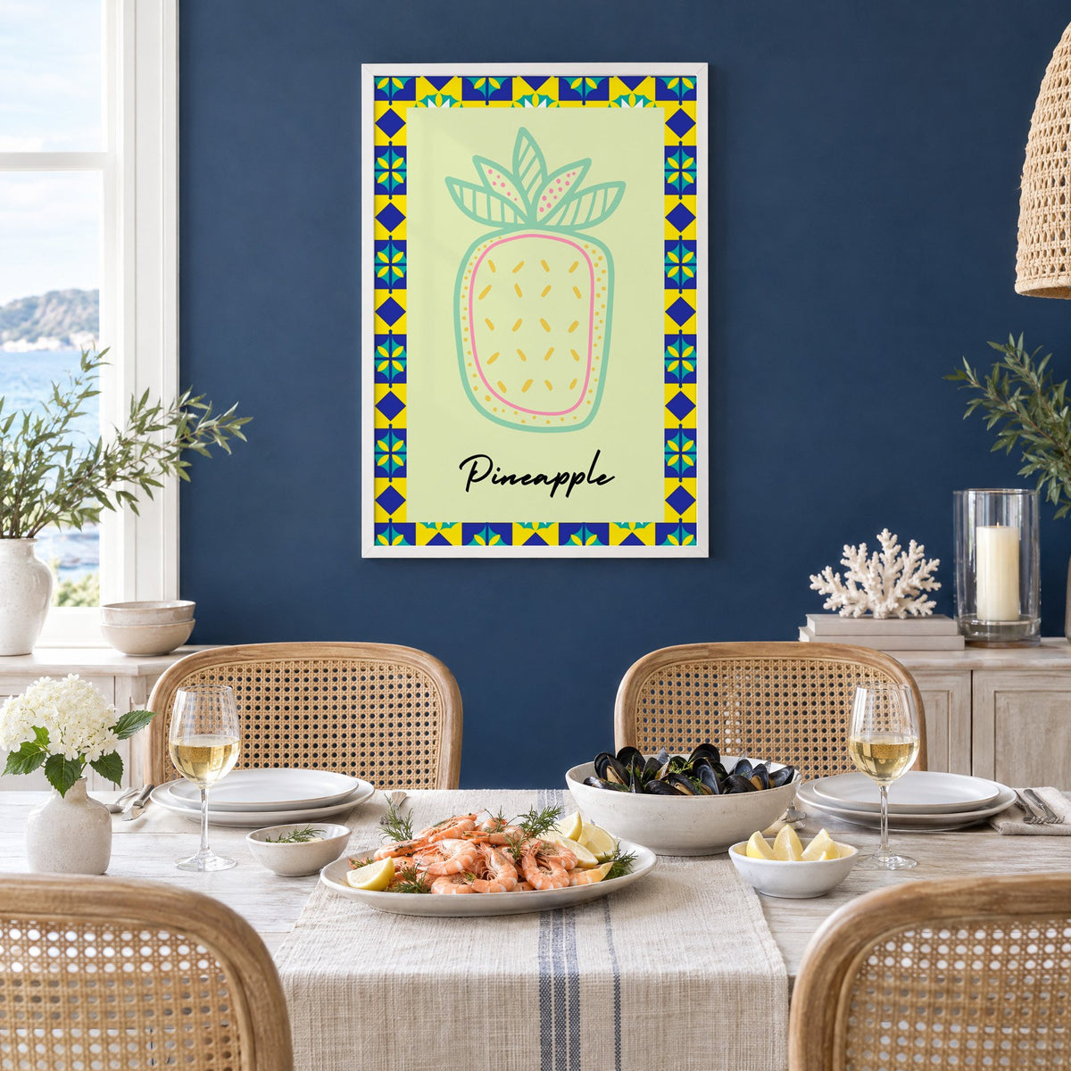 Pineapple mint line-art tile border print in a white frame on a navy wall above a dining table set with shrimp and mussels