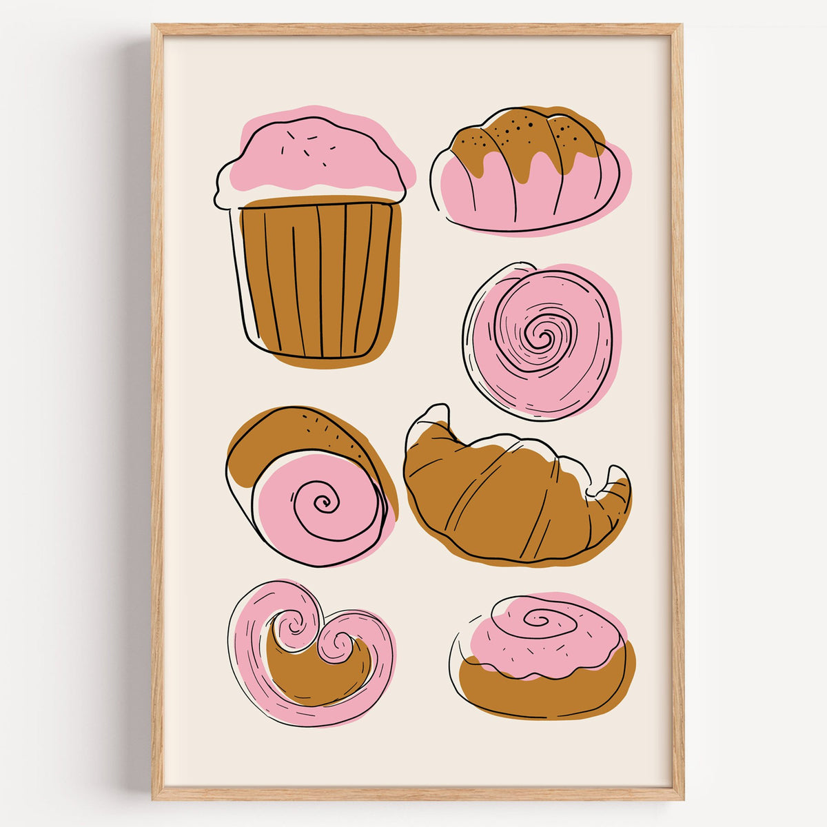 Pink and brown pastries doodle print in a light oak frame on a plain white wall