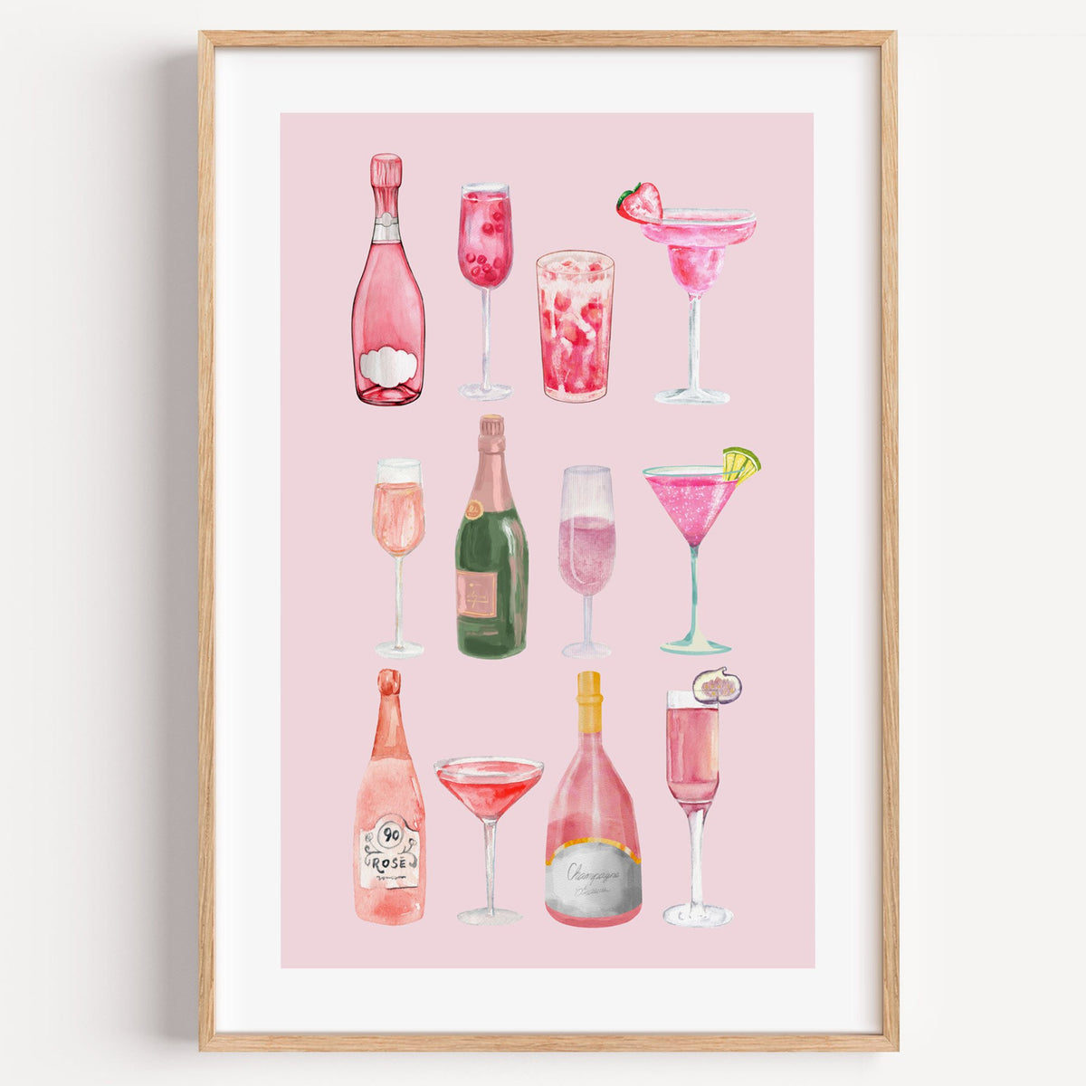 pink champagne bottles and cocktails watercolor print in a light oak frame on a plain white wall