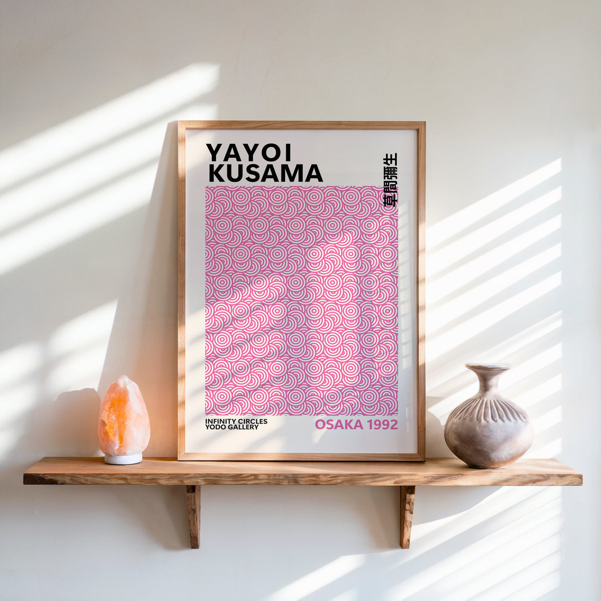 Yayoi Kusama inspired pink concentric circle print above a shelf with a salt lamp