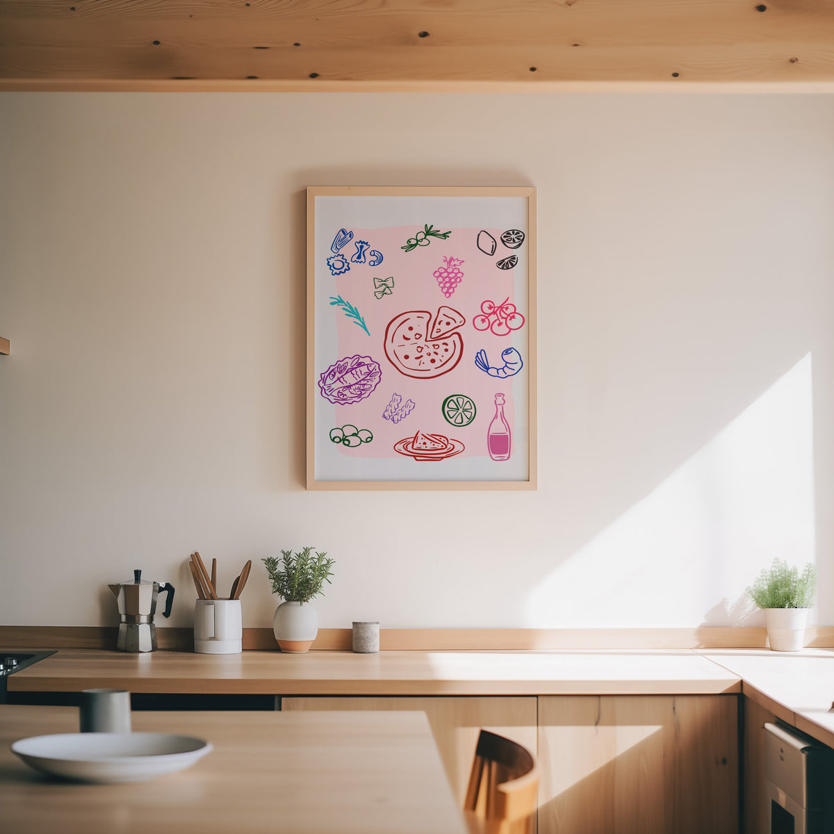 Food doodle print in an oak frame above a wood counter with a moka pot and herbs