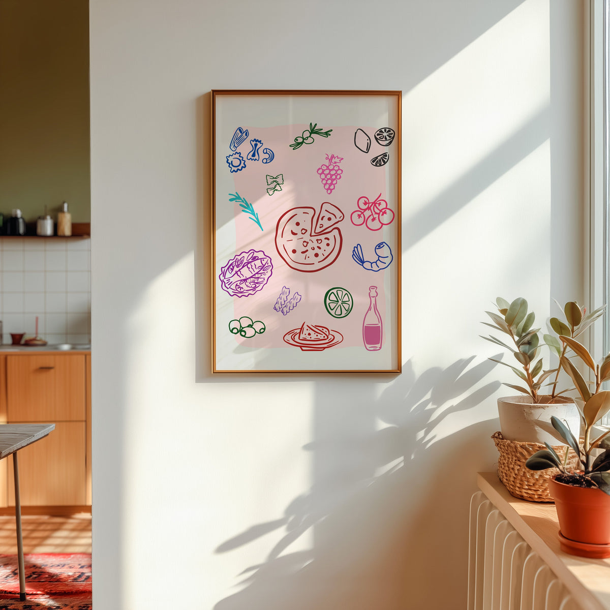 Food doodle print in a gold frame in sunlight with plants and a kitchen beyond