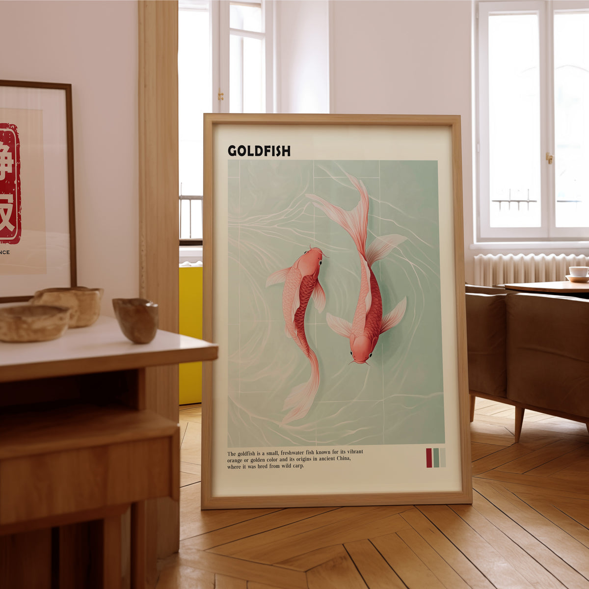 Pink goldfish pair on mint water print in an oak frame on the parquet floor of a sunlit living room