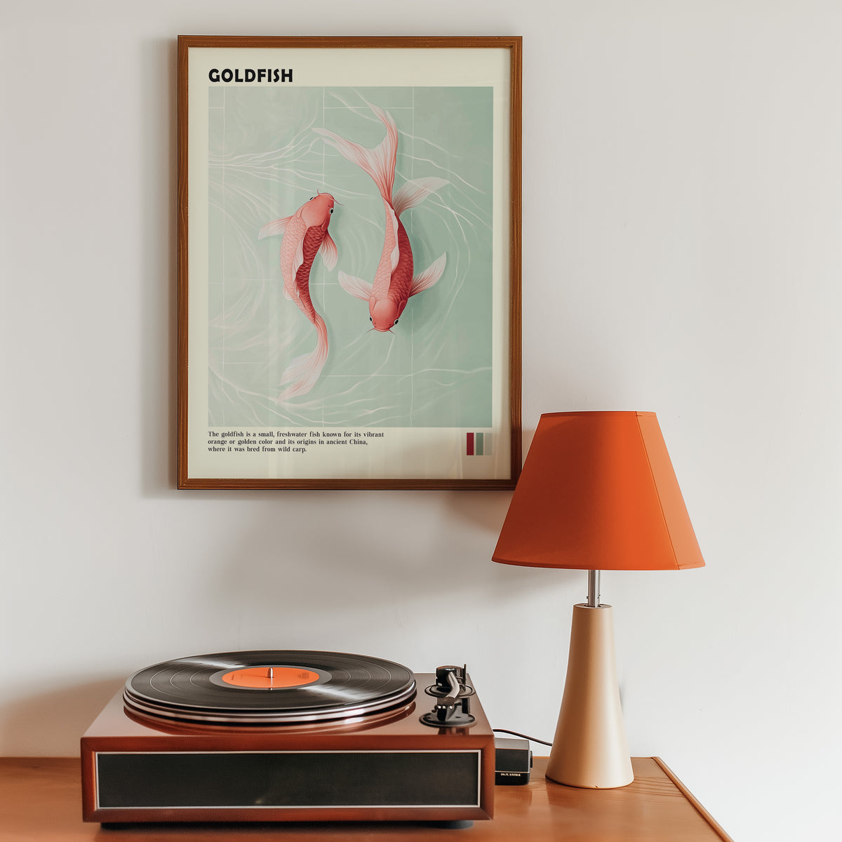 Pink goldfish pair on mint water print in a walnut frame above a sideboard with a record player