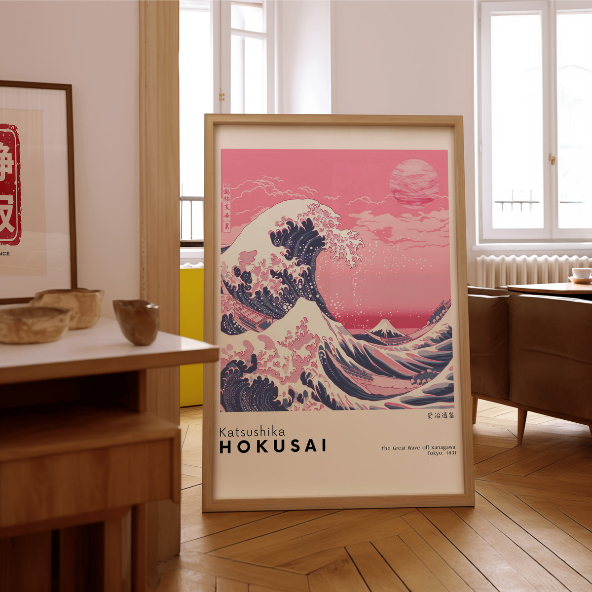 Pink Great Wave off Kanagawa print in an oak frame on the parquet floor of a sunlit living room