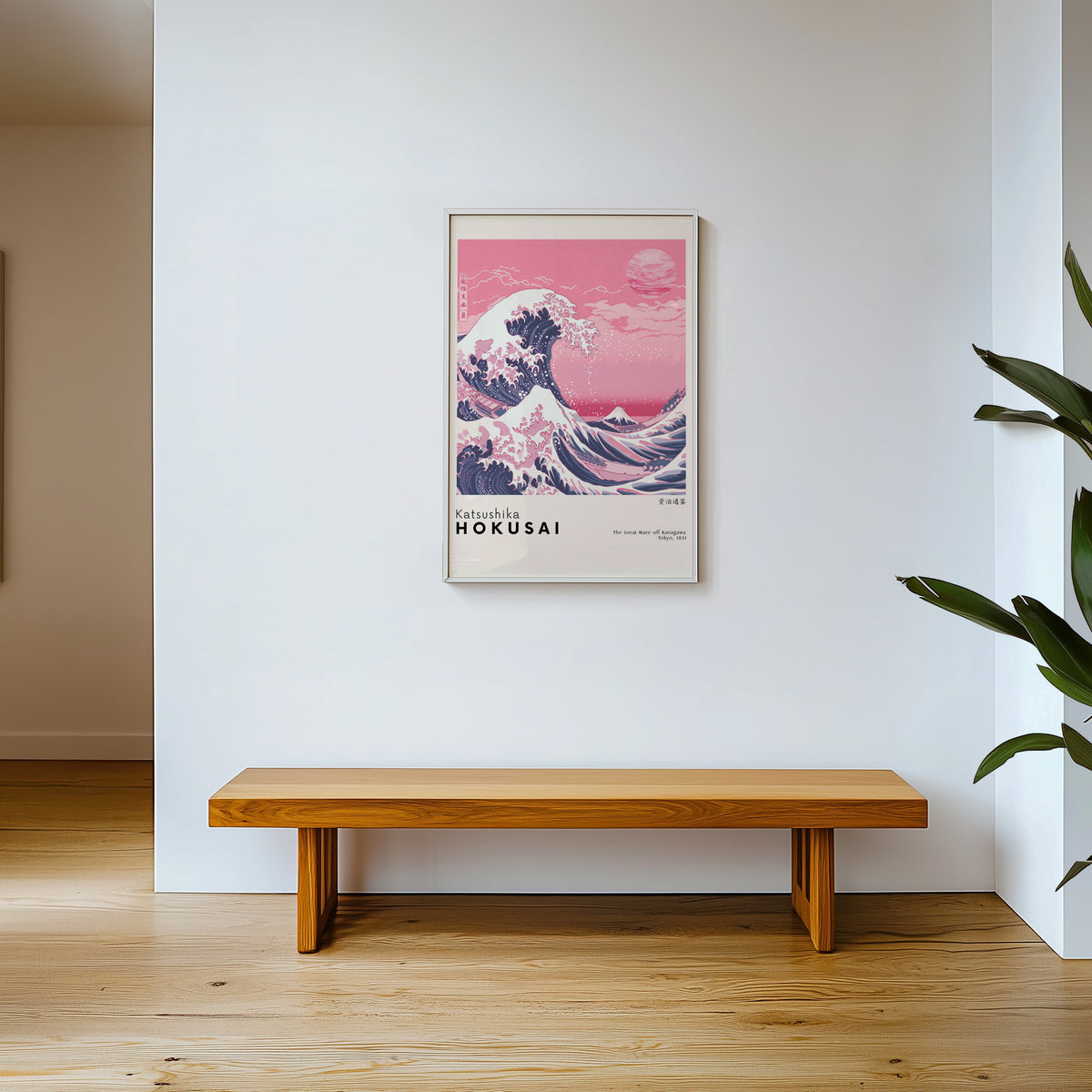 Pink Great Wave off Kanagawa print shown in a white frame above a wooden entryway bench