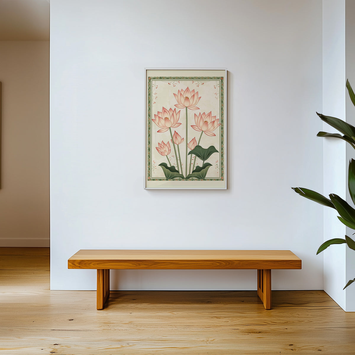 Five pink lotus flowers print shown in a white frame above a wooden entryway bench