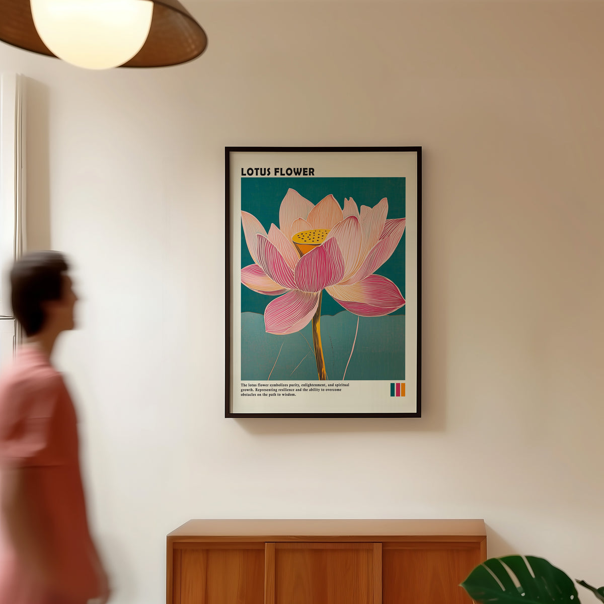 Single pink lotus on teal print in a black frame in a hallway under a rattan pendant
