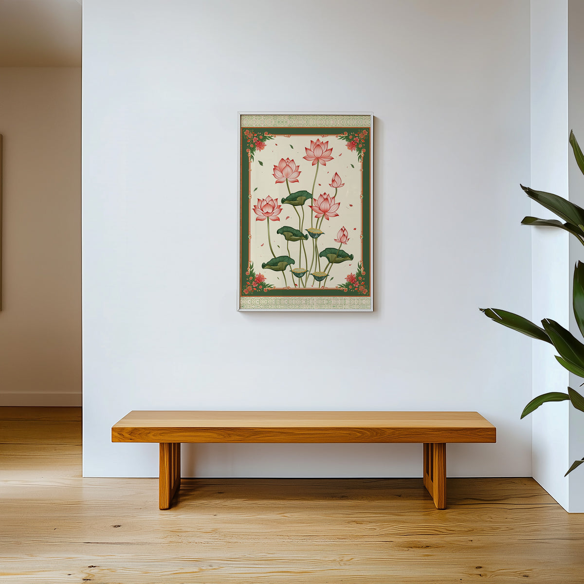 Pink lotus with green ornamental border print shown in a white frame above a wooden entryway bench