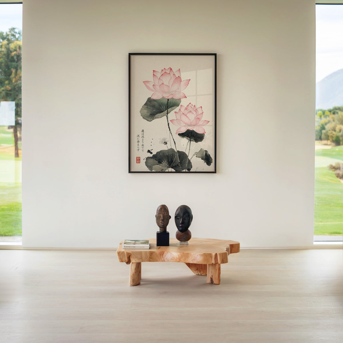 pink lotus ink painting with proverb print in a black frame above a live-edge wood coffee table between garden windows