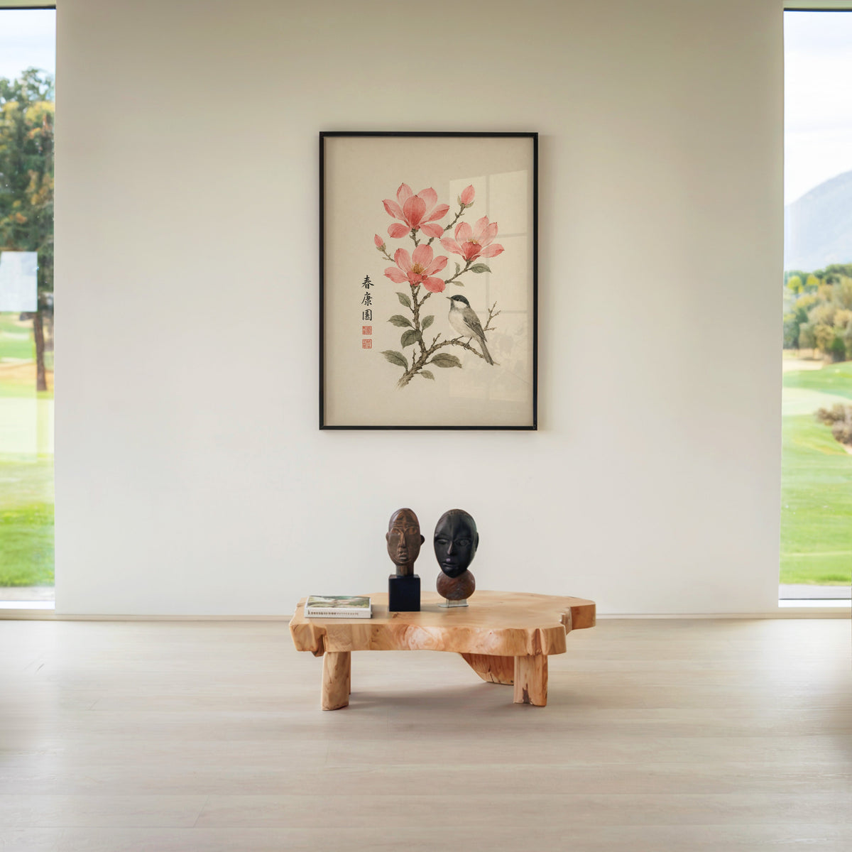 songbird on pink blossom branch print in a black frame above a live-edge wood coffee table between garden windows