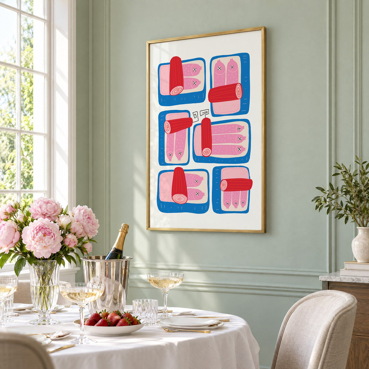 Six blue sardine tins pink fish print in a brass frame on a sage wall above a brunch table with champagne and peonies, seen at an angle