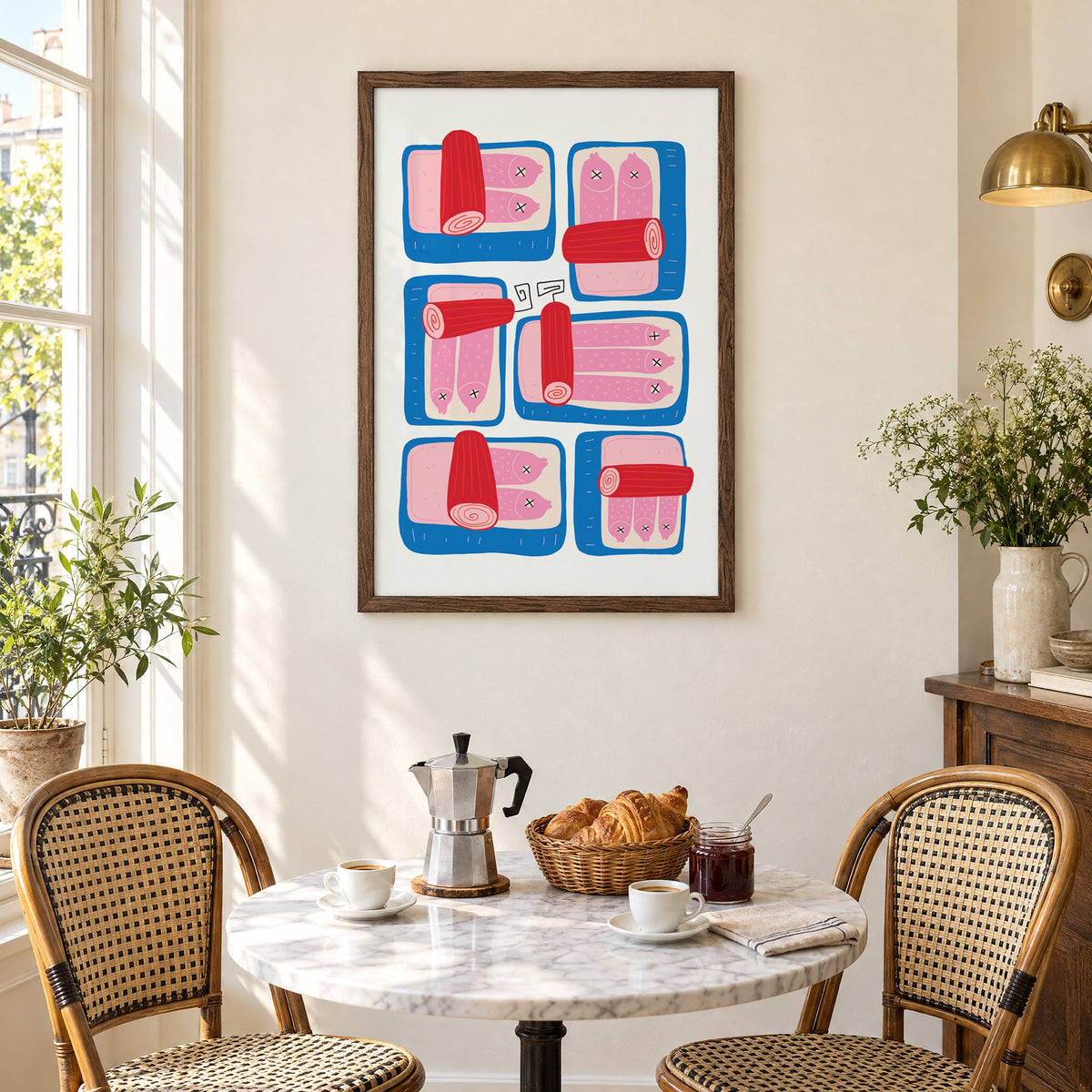 Six blue sardine tins pink fish print in a walnut frame above a marble bistro table with croissants and rattan chairs