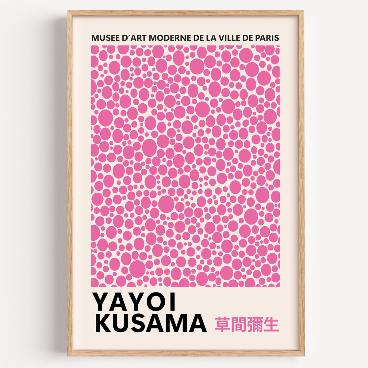 Yayoi Kusama inspired pink polka dot pattern print in a wood frame on a plain wall