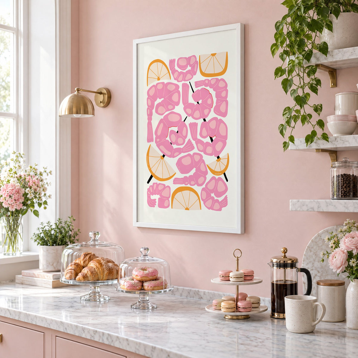 pink shrimp skewers orange wedges print in a white frame on a blush pink wall above a patisserie counter with croissants and macarons, seen at an angle
