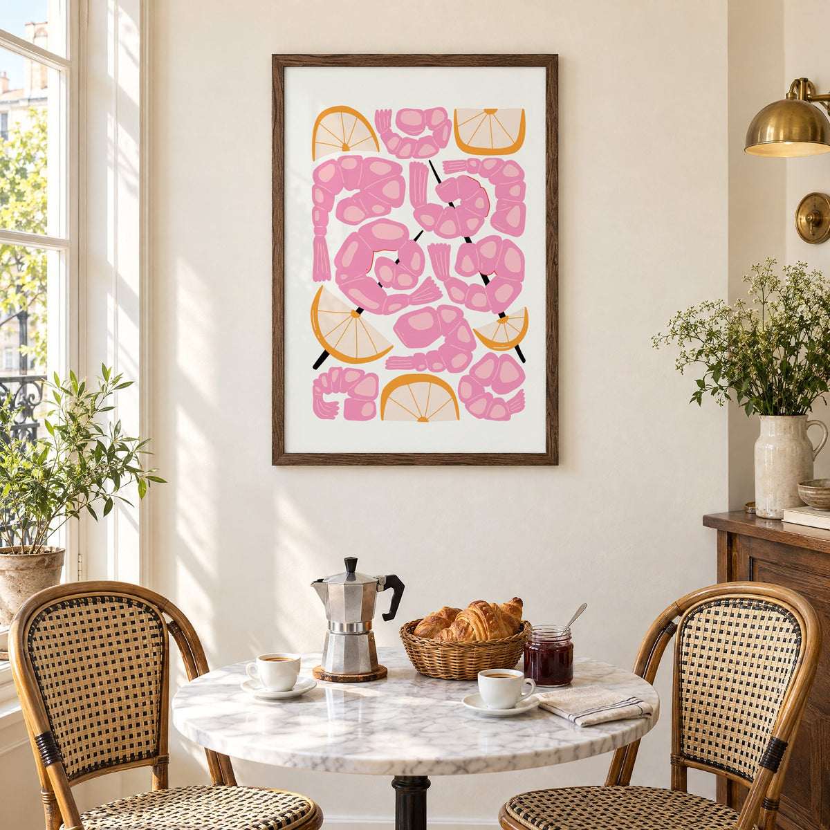 pink shrimp skewers orange wedges print in a walnut frame above a marble bistro table with croissants and rattan chairs