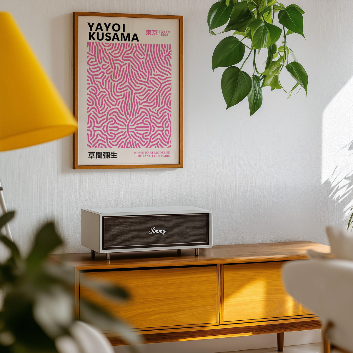 Yayoi Kusama inspired pink squiggle pattern print above a sideboard with a plant