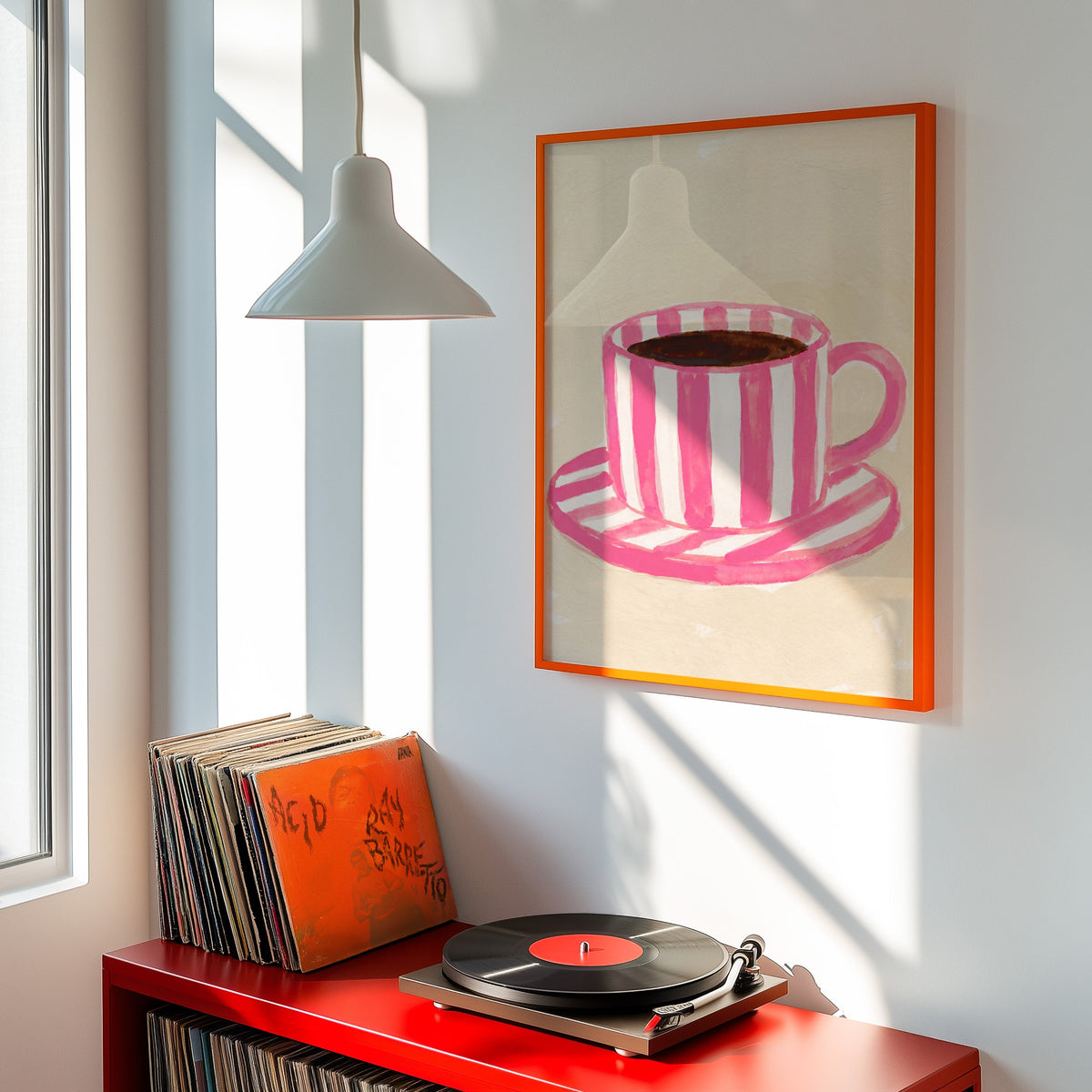 Coffee and saucer print shown in an orange frame above a red record cabinet and turntable