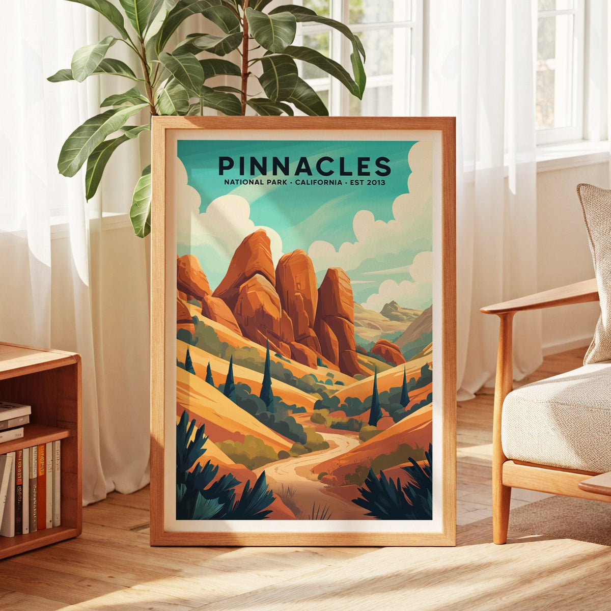 Pinnacles National Park print in an oak frame by a sunlit window with sheer curtains and a fig plant