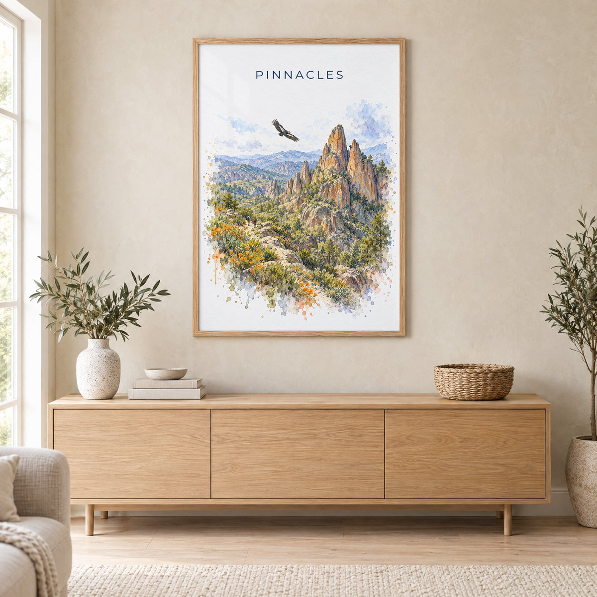 Pinnacles National Park watercolor print in an oak frame above a light wood sideboard in a Scandinavian living room