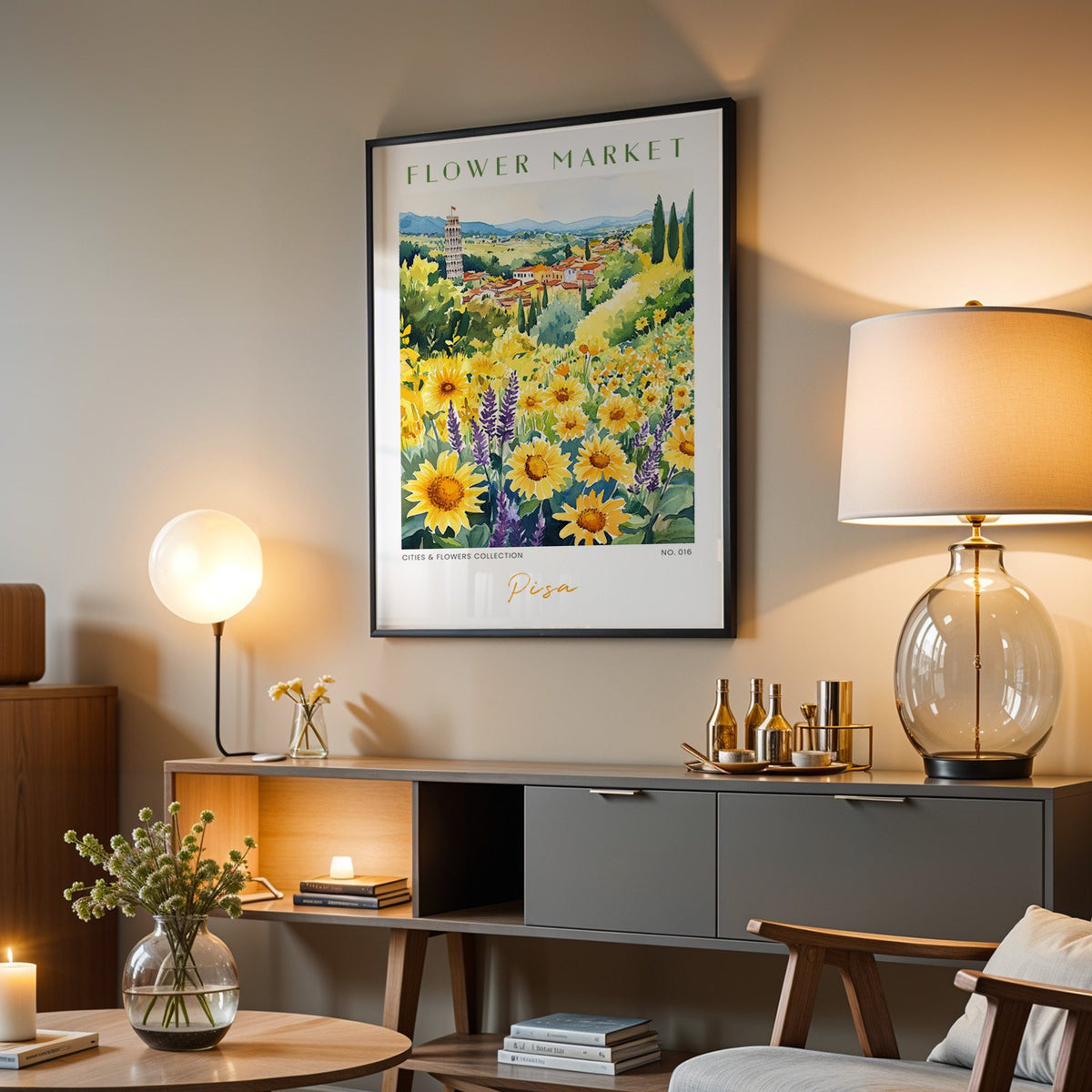 Pisa flower market print in a black frame above a grey media console with a glass table lamp
