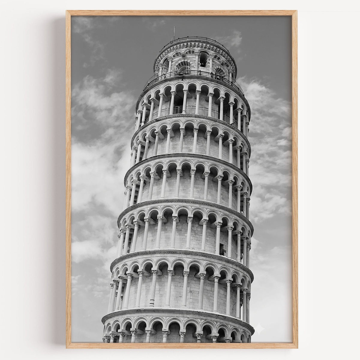 Leaning Tower of Pisa arcades from below print in a light oak frame on a plain white wall