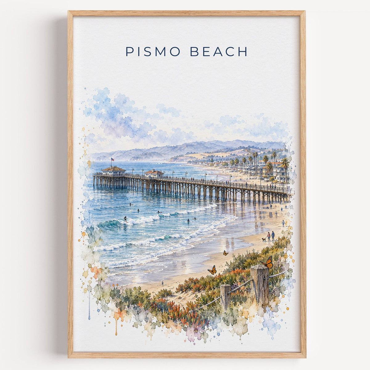 Pismo Beach watercolor print in a light oak frame on a plain white wall