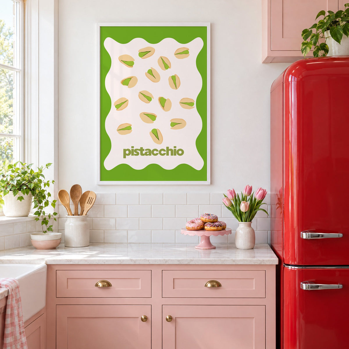 pistacchio pistachio nuts green wavy frame print in a white frame above pink cabinets beside a red retro fridge