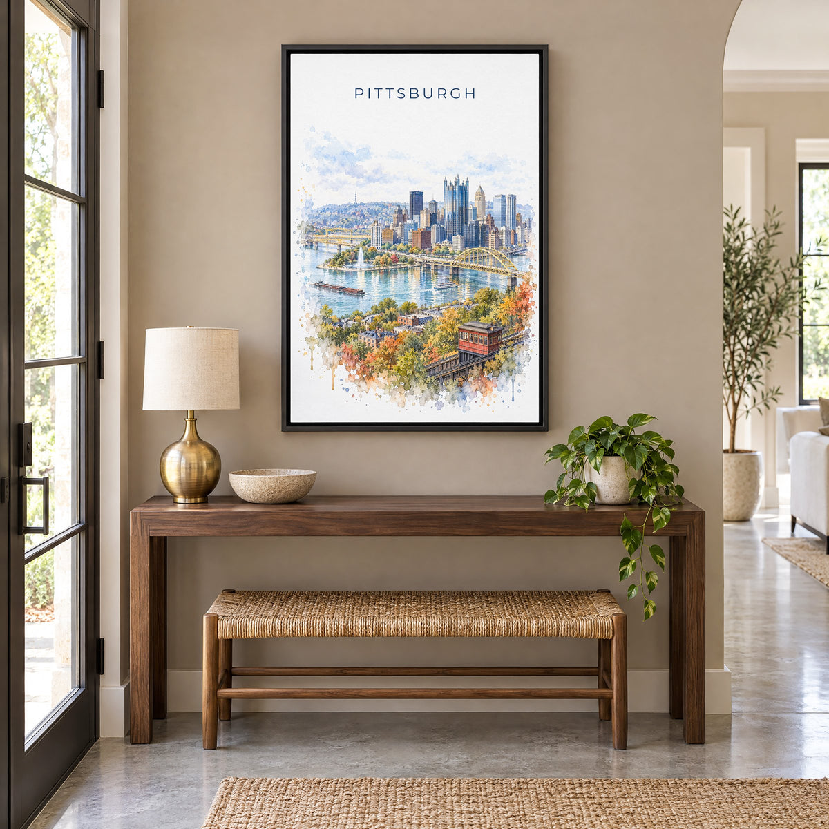 Pittsburgh watercolor print as a black floater canvas above a walnut console and woven bench in an entryway