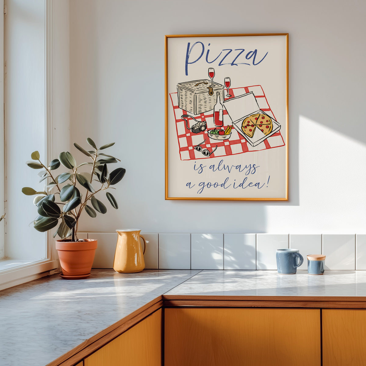 Pizza picnic print in a gold frame above a marble counter with a yellow ceramic jug