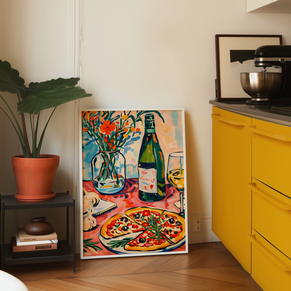 Pizza and champagne print in a white frame on parquet beside a yellow kitchen