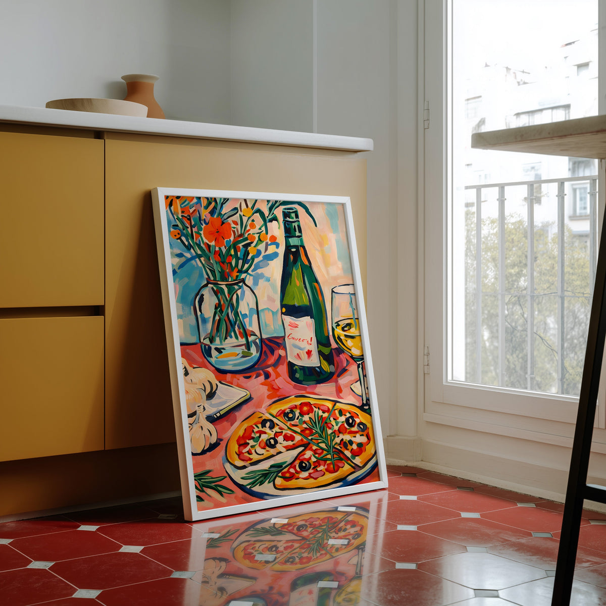Pizza and champagne print in a white frame against yellow cabinets on red tiles