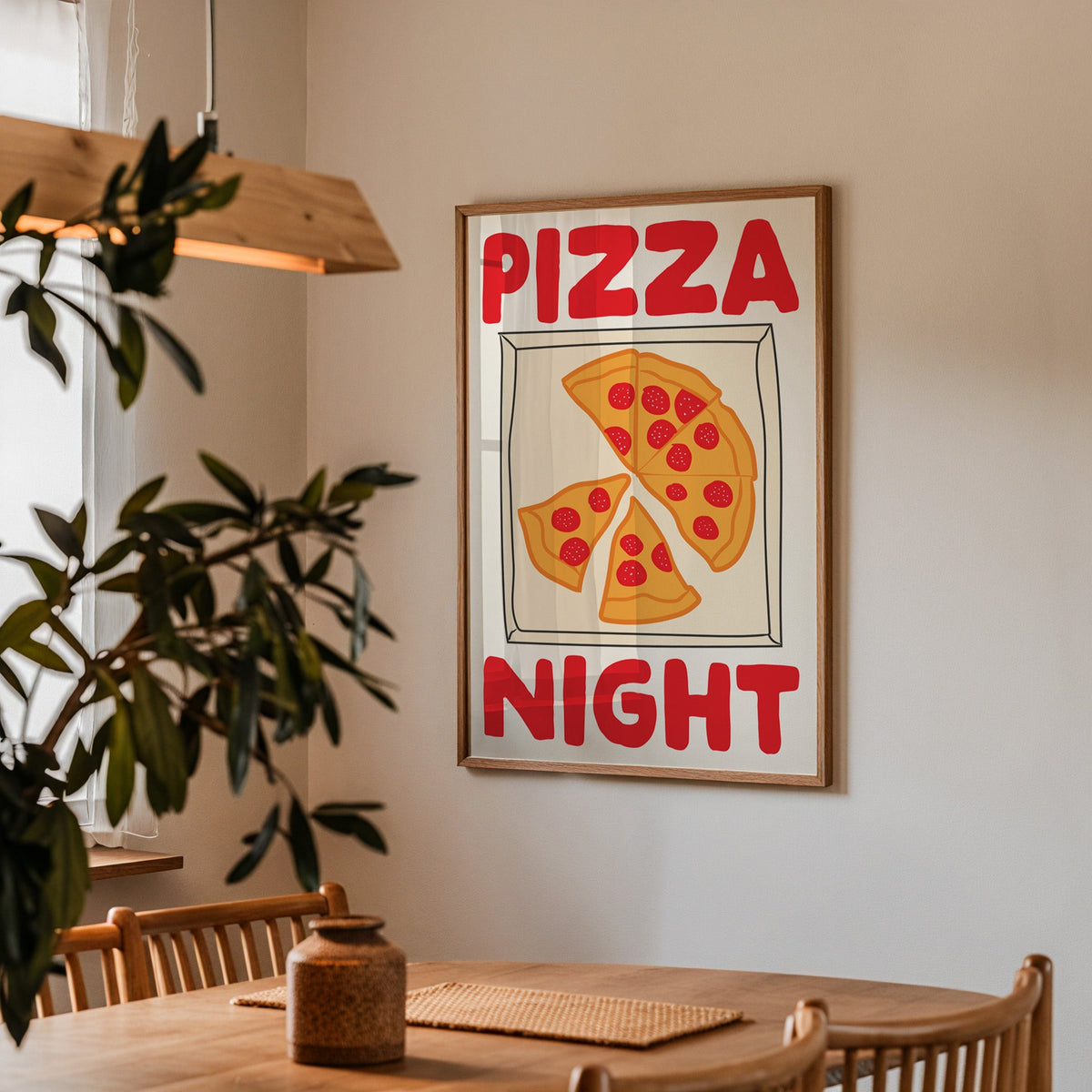 Pizza night pepperoni box print in a walnut frame above a table beside an olive tree