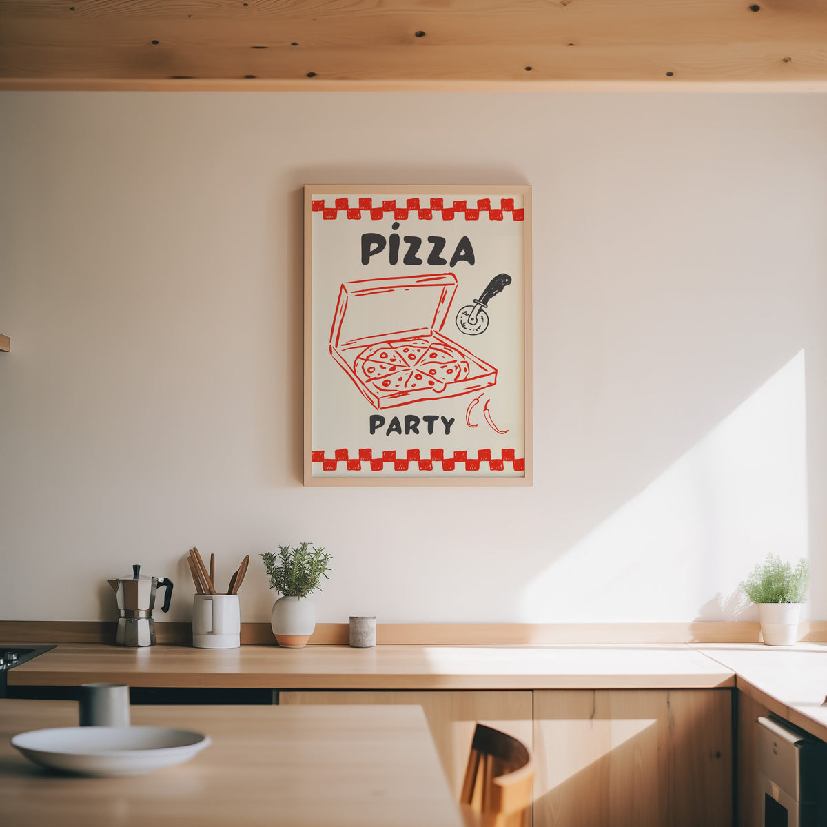 Pizza Party print in an oak frame above a wood counter with a moka pot and herbs